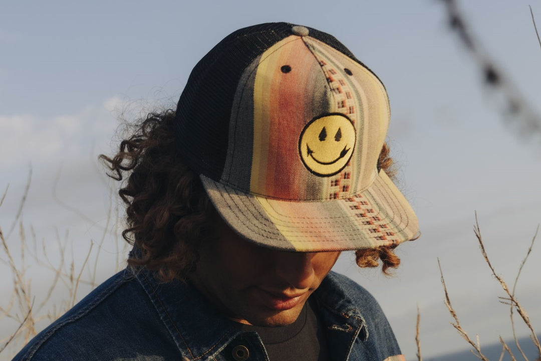 Smiling arrow sunset design trucker hat by Steven Paul Judd