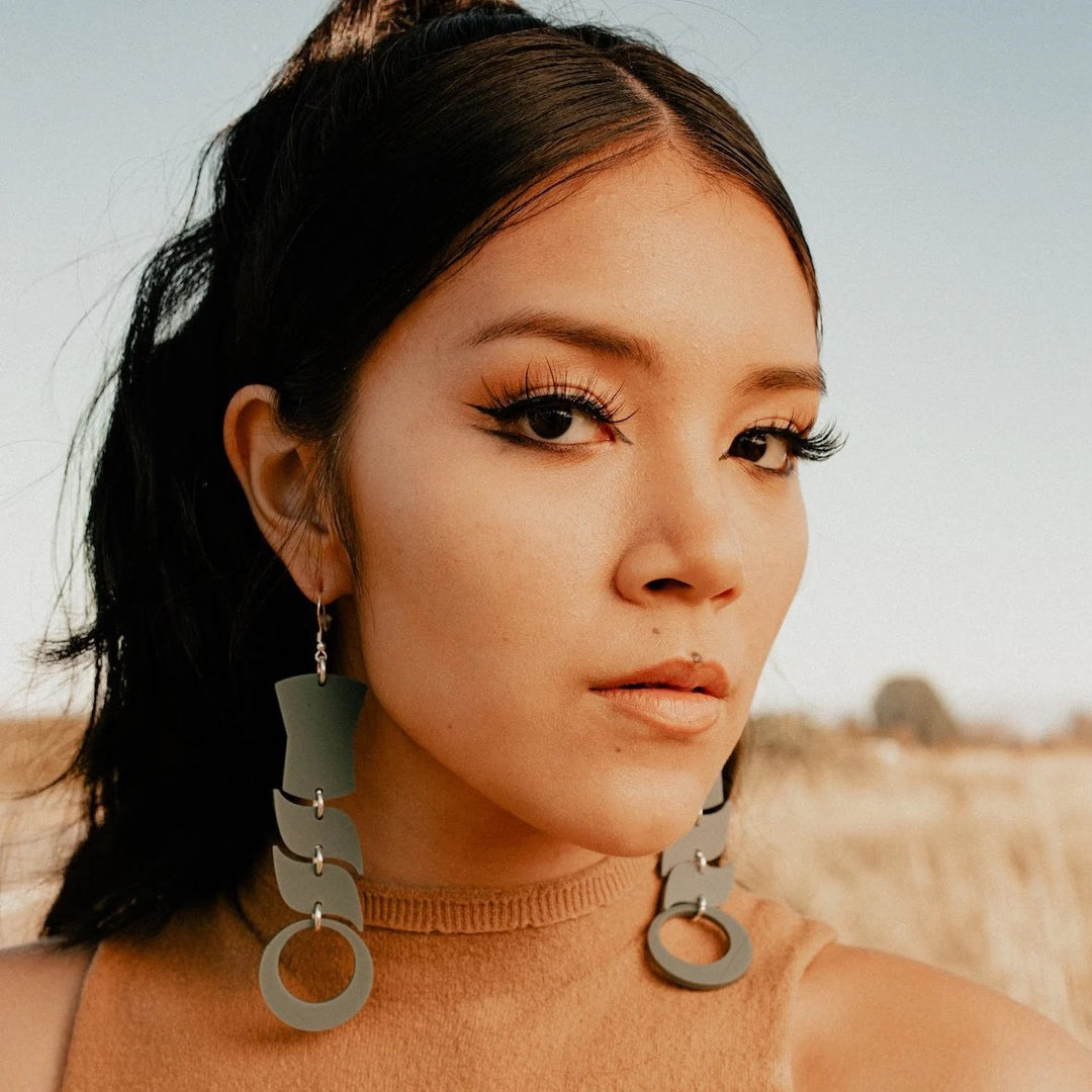 Indigenous woman wearing Handmade Sage colored earrings by Native American women name Spirit Flow