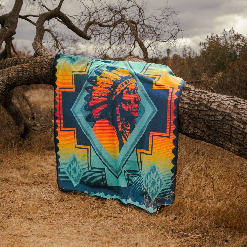 Hung over tree a Sitting Bull Native American wool blanket by Ginew and Steven Paul Judd woven by Pendleton