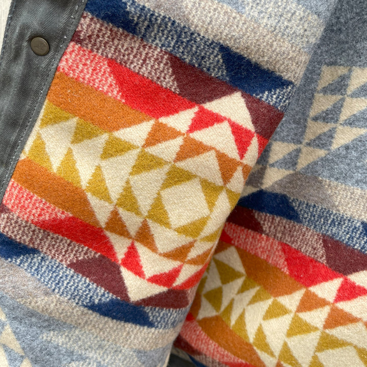 Lining close up on Dark green herringbone rider coat with colorful wool lining by Pendleton and made in USA by Native American, Indigenous Ginew 
