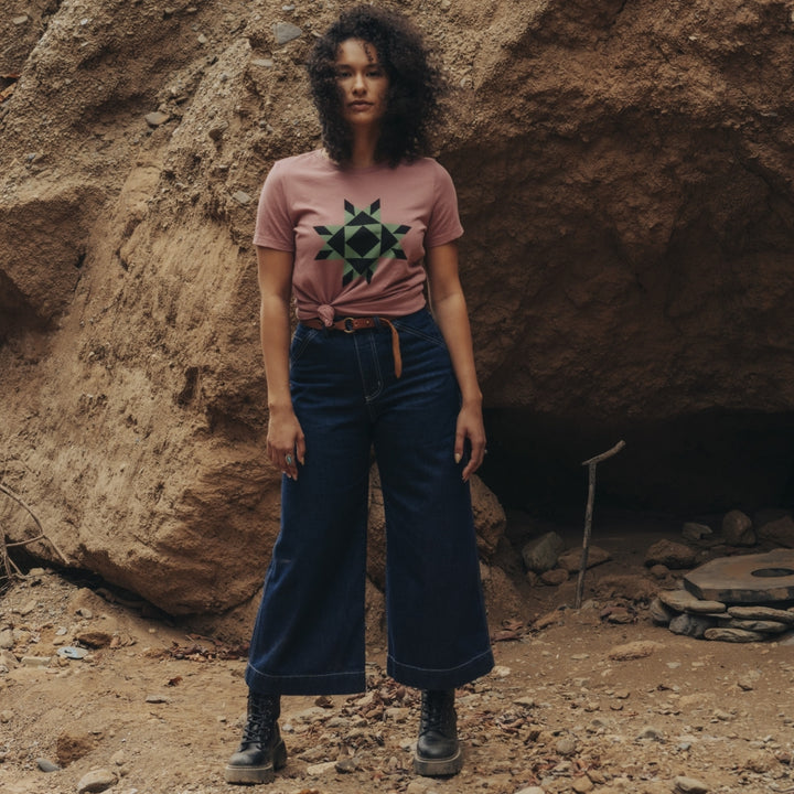 Women wearing muted pink tshirt with star design on the front 