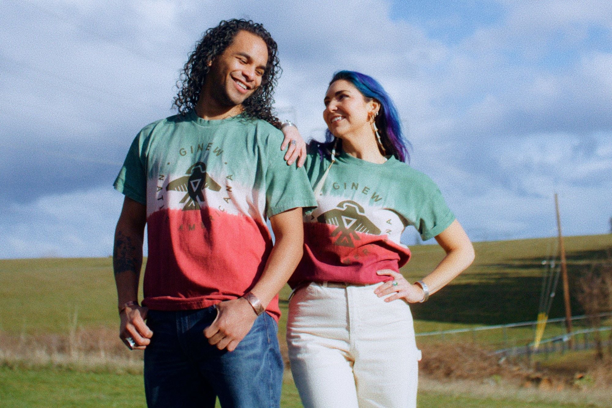 Tie dye Native Thunderbird t-shirt on couple in field 