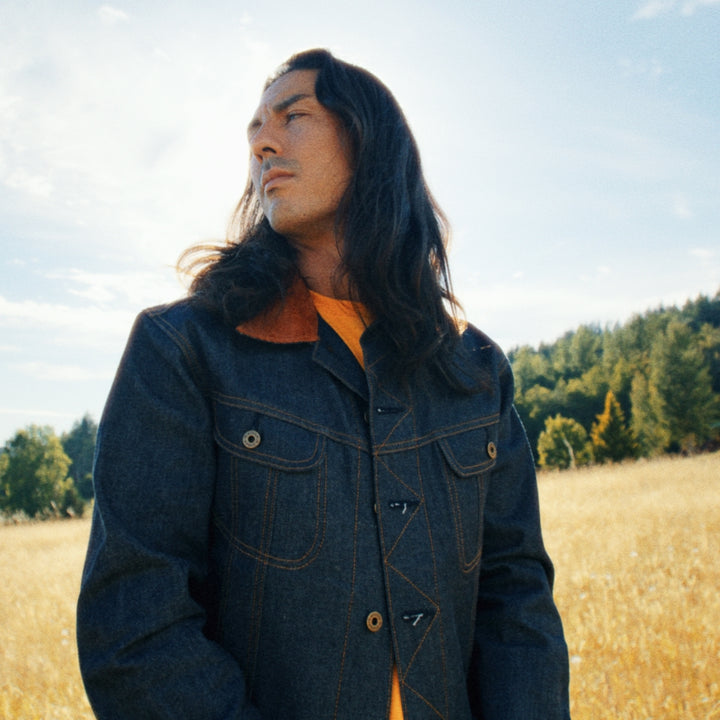 Native American wearing Vidalia denim jean jacket with corduroy collar in field 