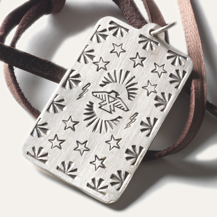 Silver pedant tag necklace Native American made necklace with a Thunderbird design hangs on leather lace. 