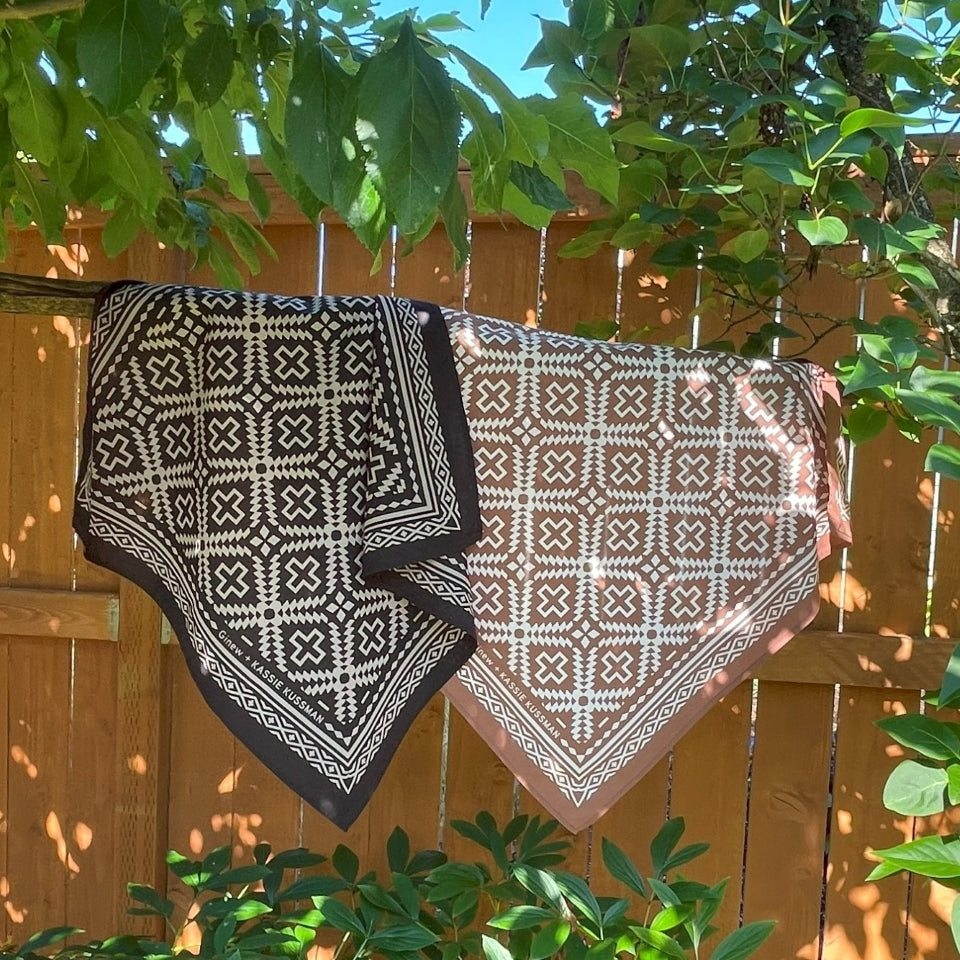 Hanging on branch Native American Indigenous Artist designed cotton bandana in brown and natural white and black and natural white made by Ginew 