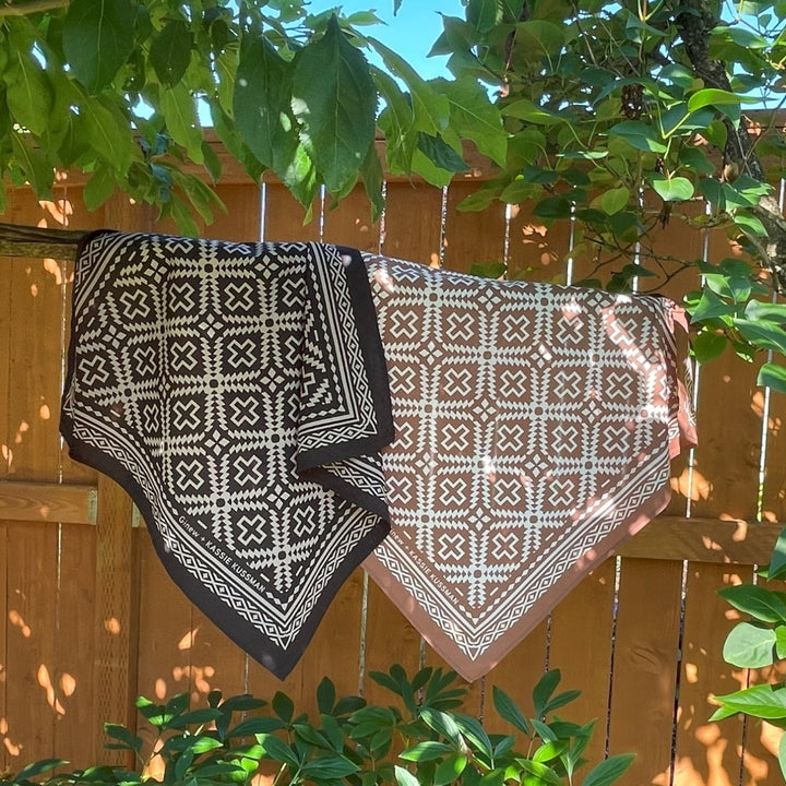 Hanging on branch Native American Indigenous Artist designed cotton bandana in brown and natural white and black and natural white made by Ginew 