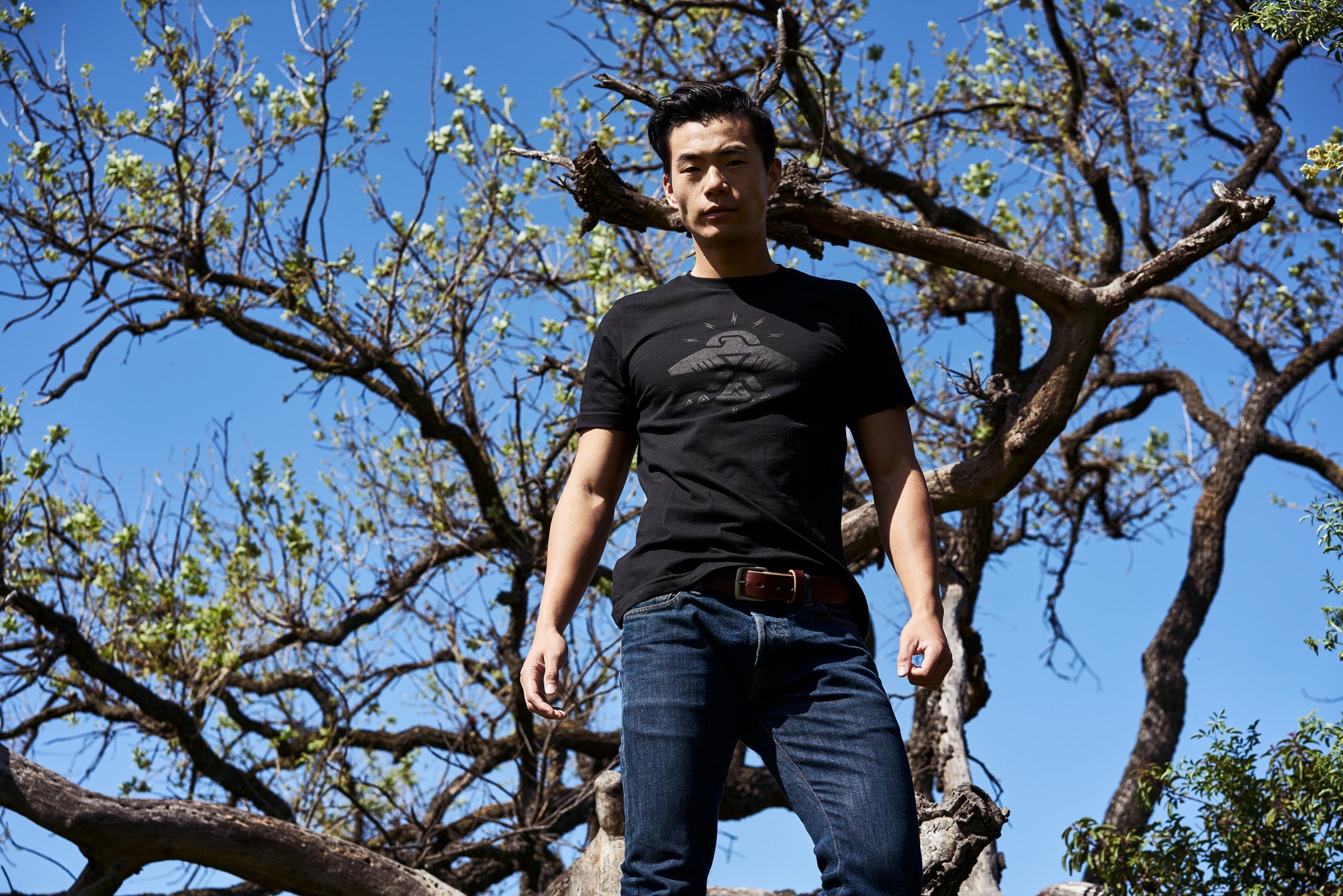 Native American Thunderbird t-shirt on man in woods