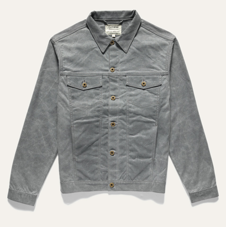 Full front view of Wax Canvas Rider Jacket in Charcoal. Features two front chest and side pockets and custom Ginew hardware (buttons). Jacket on a neutral background.