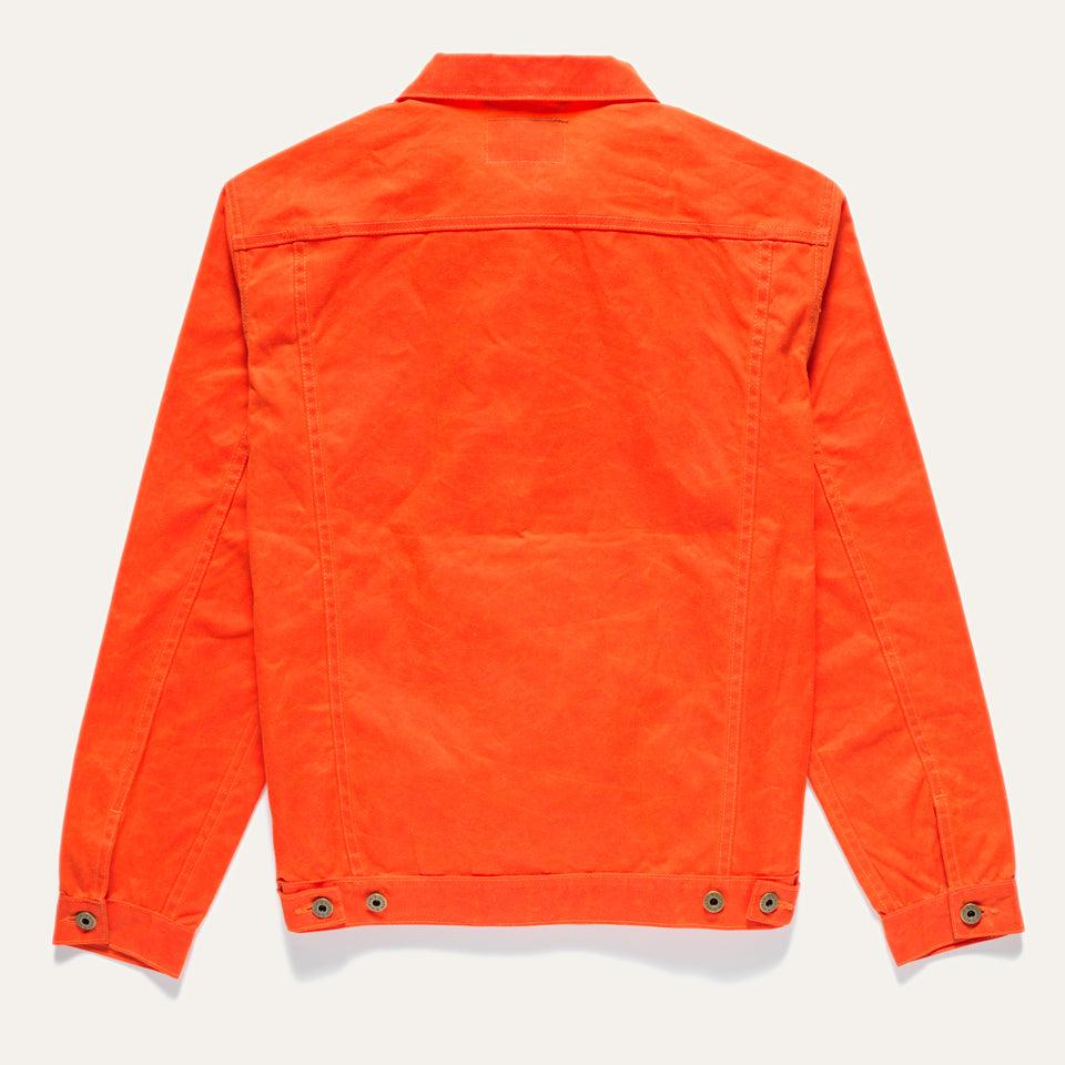 Full back view of Wax Canvas Rider Jacket in Orange on neutral background.