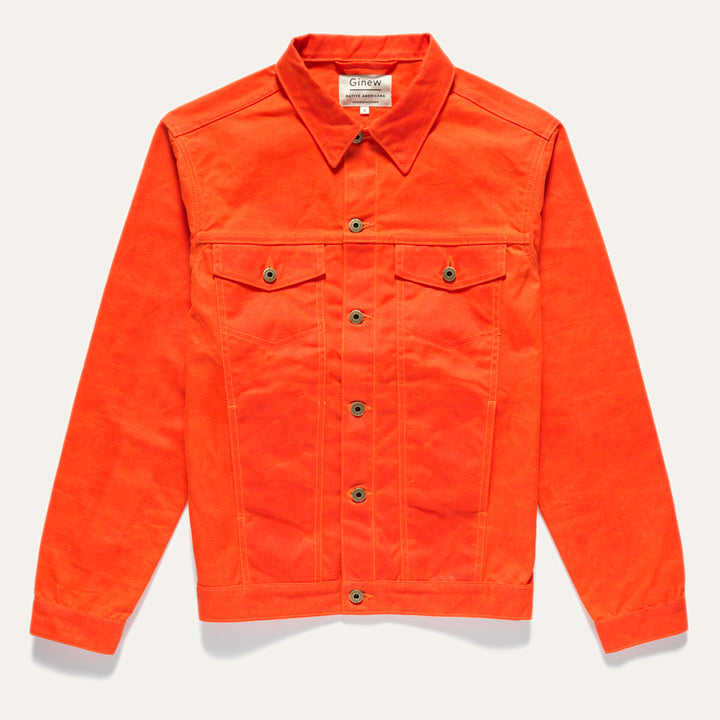 Front of orange Wax Canvas Rider Jacket. Features two front chest and side pockets and custom Ginew hardware (buttons). Jacket on a neutral background.