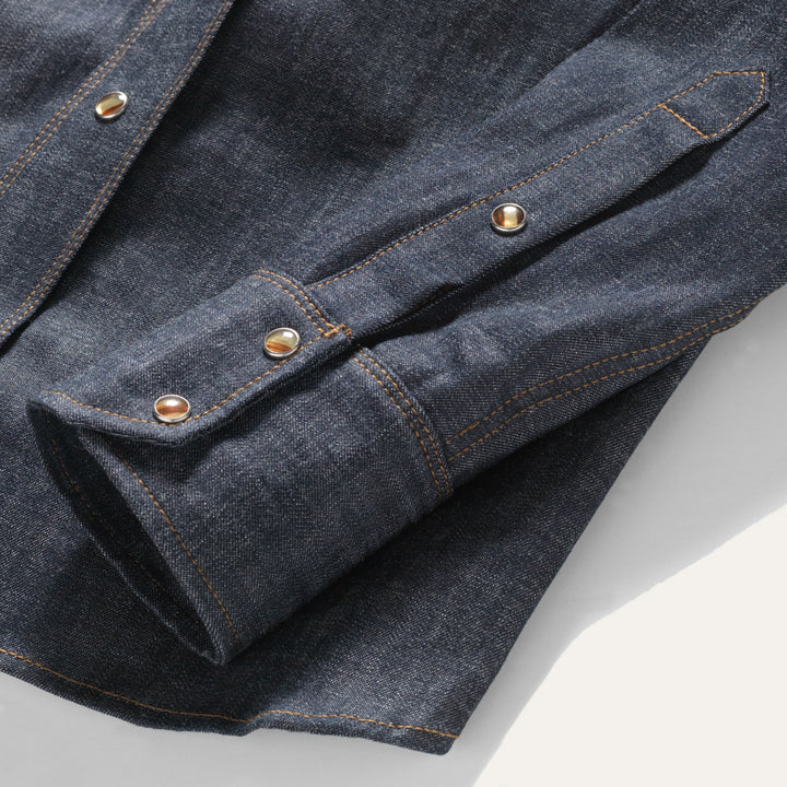 Close up of three button cuff on all cotton chambray western snap with faux tortoise shell snaps.