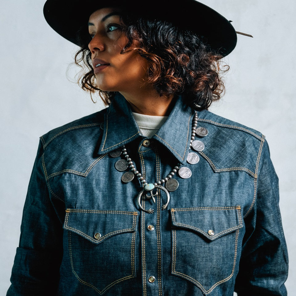 Women wearing denim Western snap shirt made in USA by Ginew with Native American designed jewelry