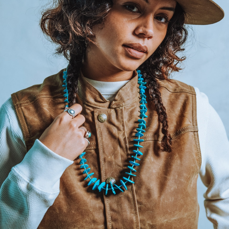 Woman wearing brown Ginew wax canvas vest 