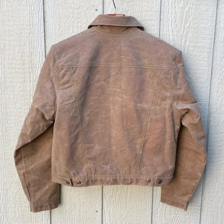 Back of Women's brown wax canvas coat with colorful, southwest Pendleton wool lining with Native American Ginew tag
