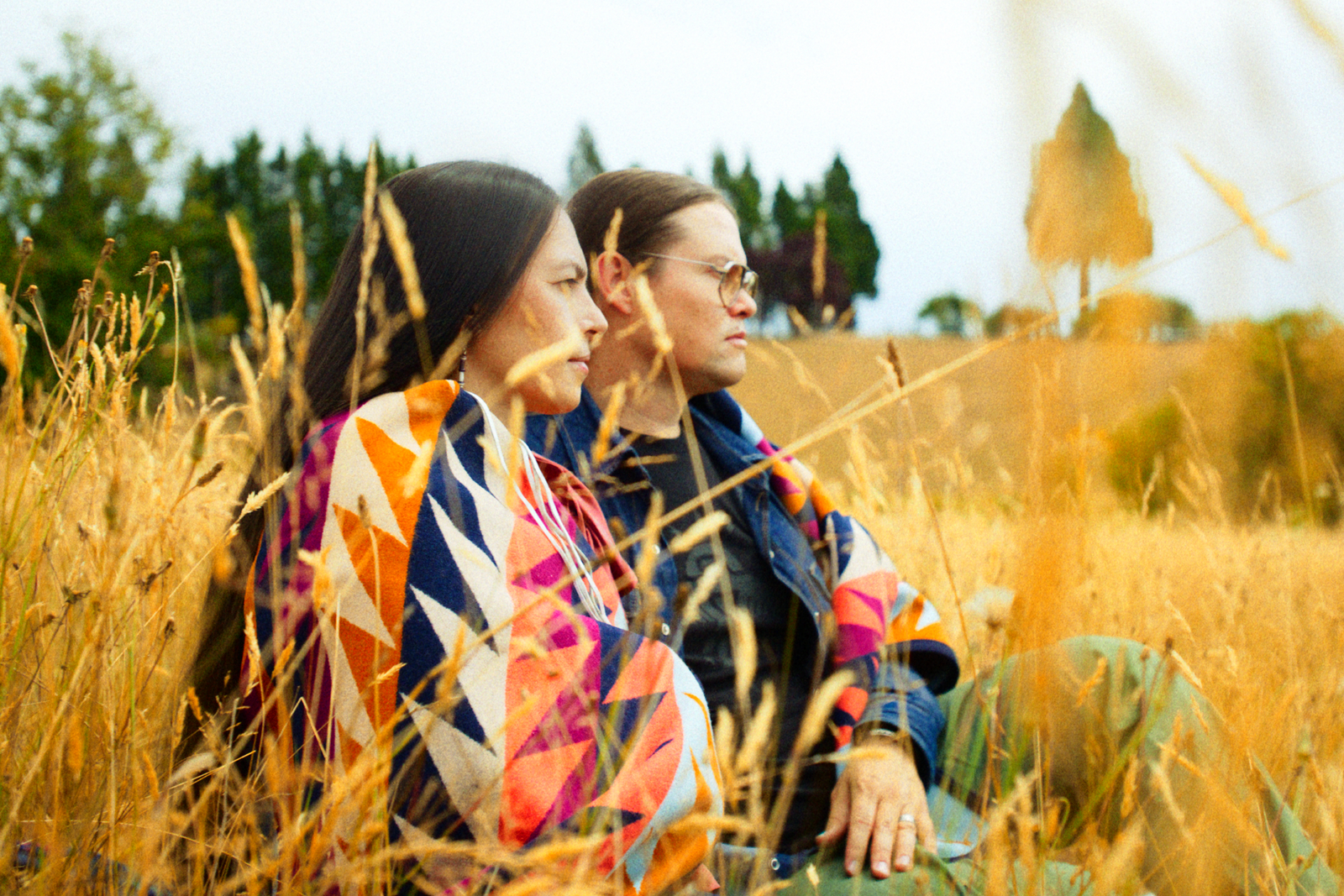 Native American cofounders wrapped in Indigenous designed wool blend blanket