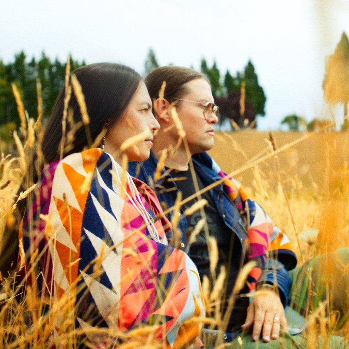 Native American Indigenous Amanda Bruegl and Erik Brodt Co-founders of Ginew wrapped in Addie Roanhorse Gently Strikes blanket 