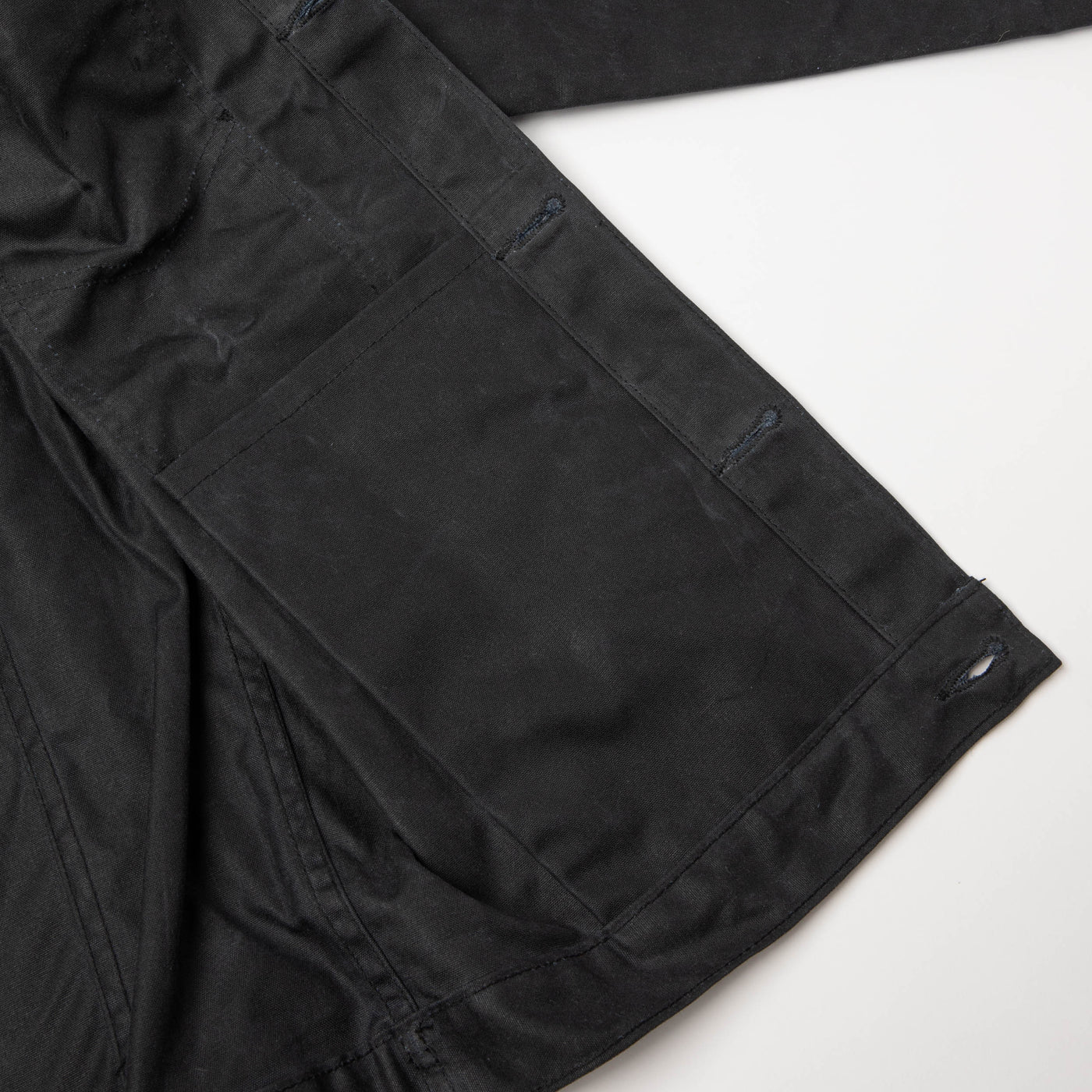 Detail view of internal pocket on left side of Jacket. On a neutral background.