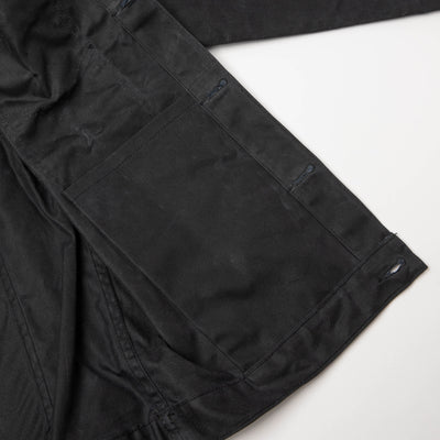 Detail view of internal pocket on left side of Jacket. On a neutral background.