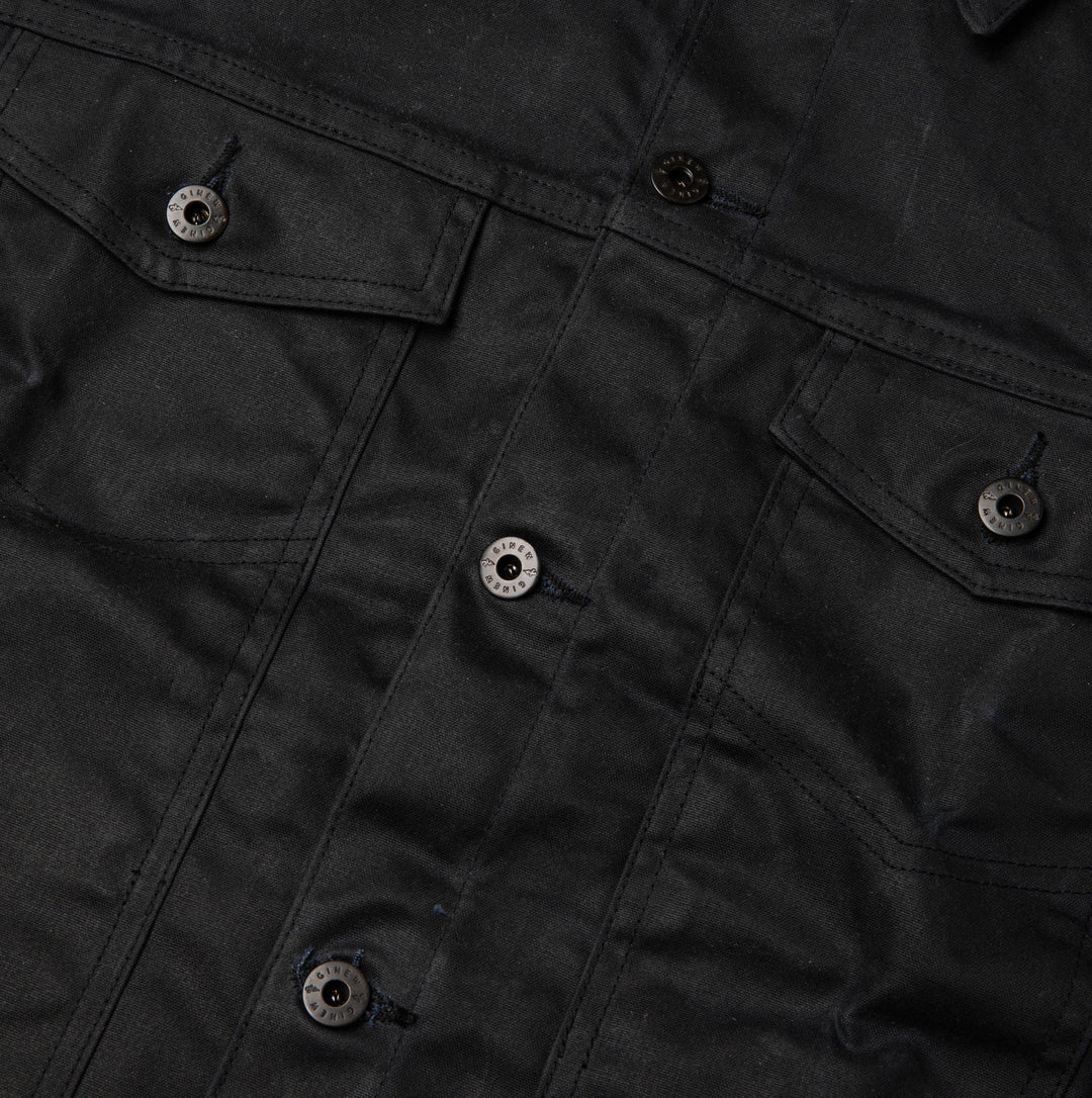 Detail view of front chest pockets and buttons.