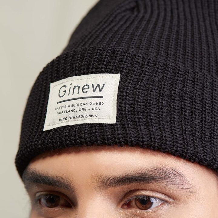 Close up of Native American wearing black merino wool watch cap made in USA by Ginew