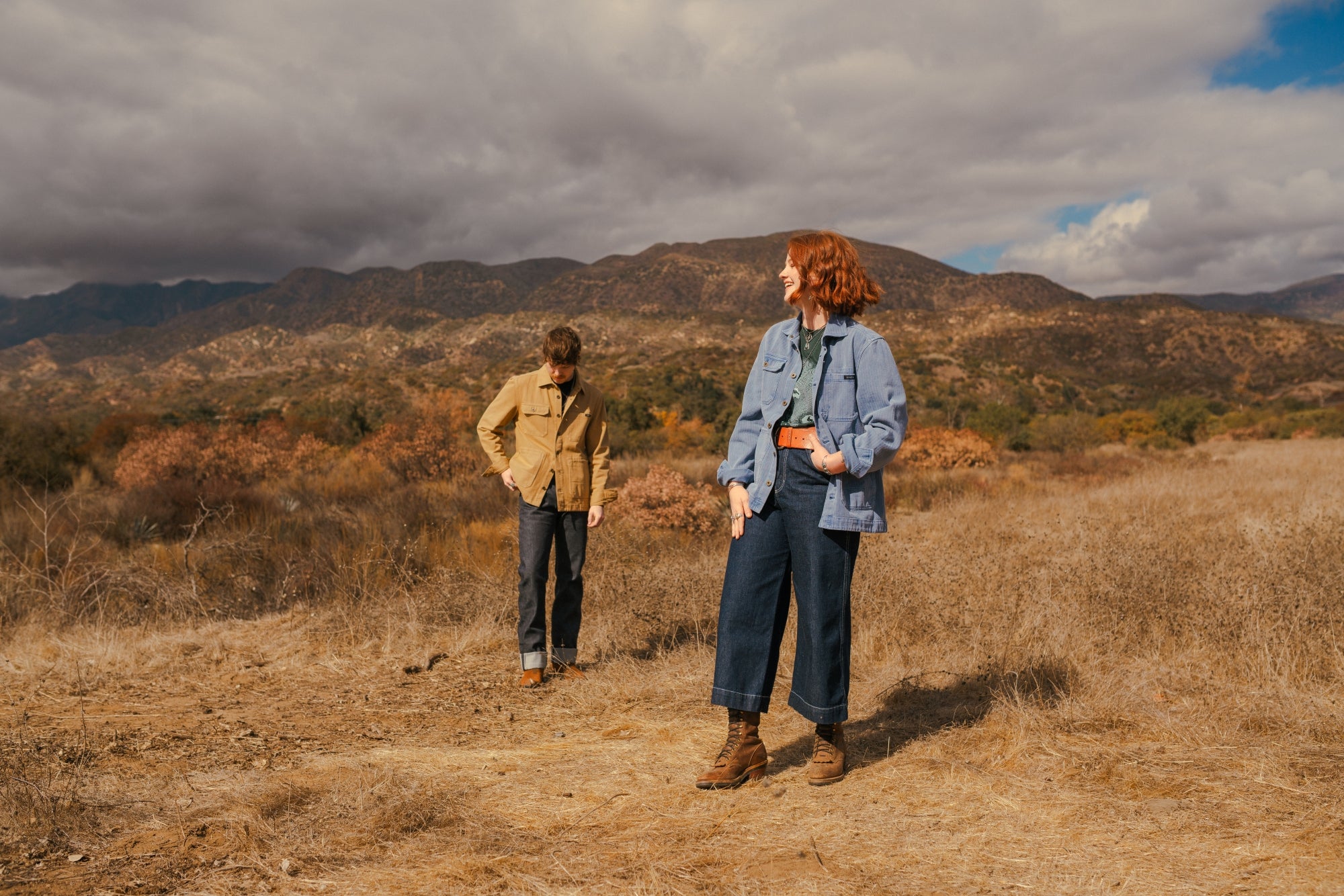 Blue and tan cotton barn coats by Indigenous Ginew on man and women in field