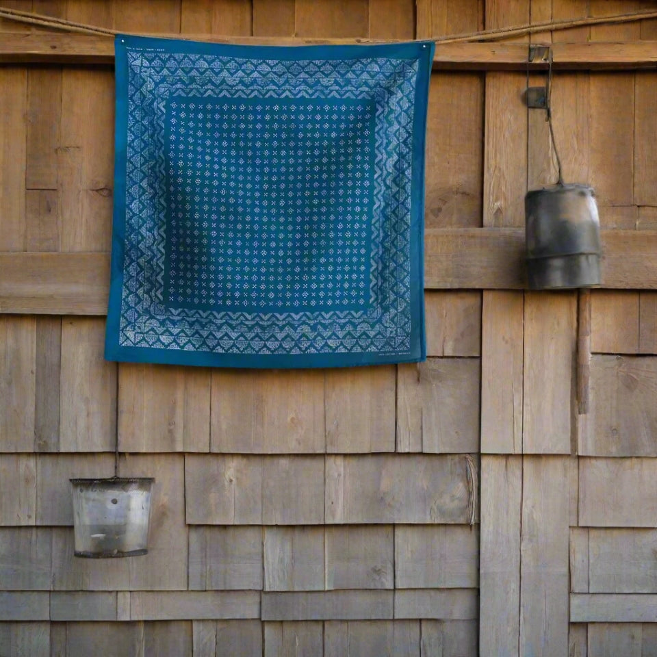 Light blue cotton bandana by Ginew on side of barn