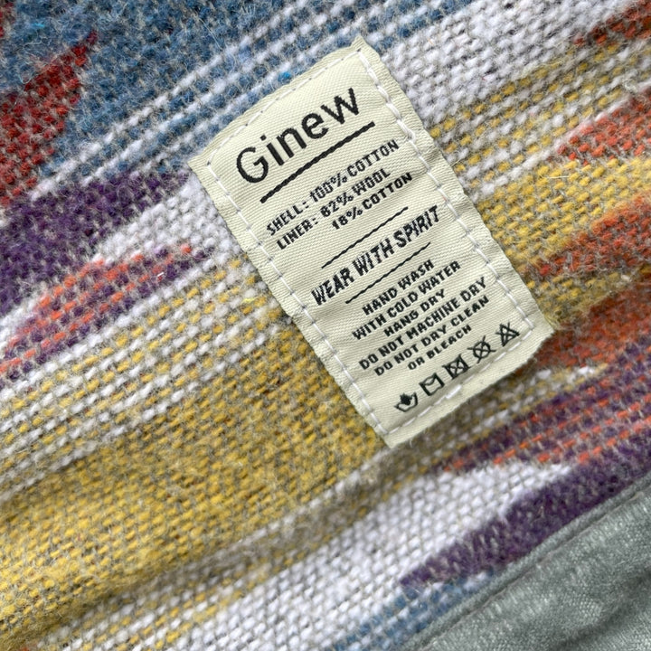 Care tag on Gray silver charcoal wool lined coat with a colorful Native American patterned lining by Ginew