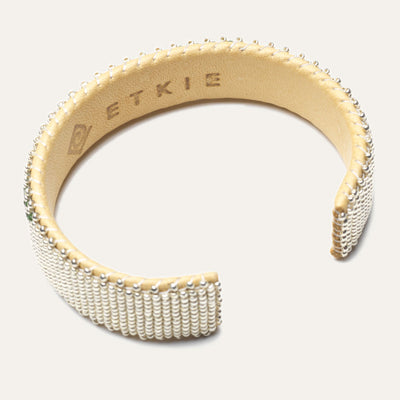 Inside shot of bracelet; leather lining with "Etkie" etched in
