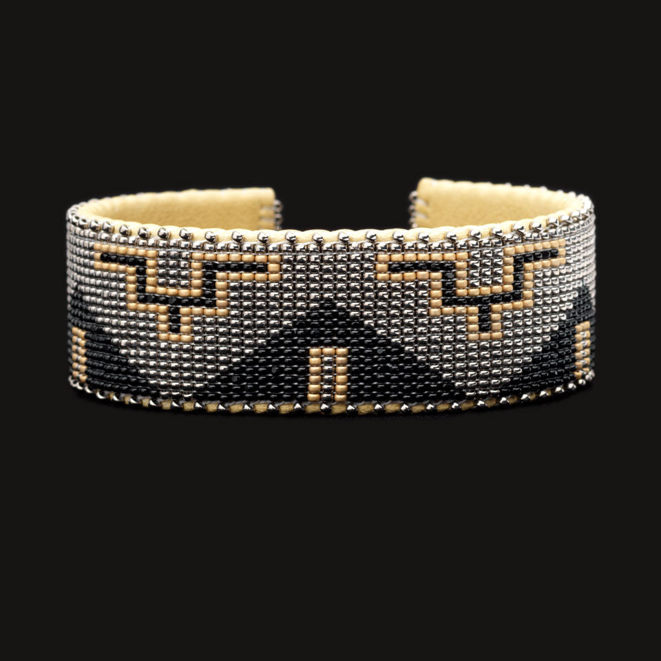 Silver, black and gold design. Hand-beaded bracelet; black background