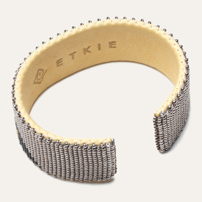 Inside shot of bracelet; leather lining with "Etkie" etched in