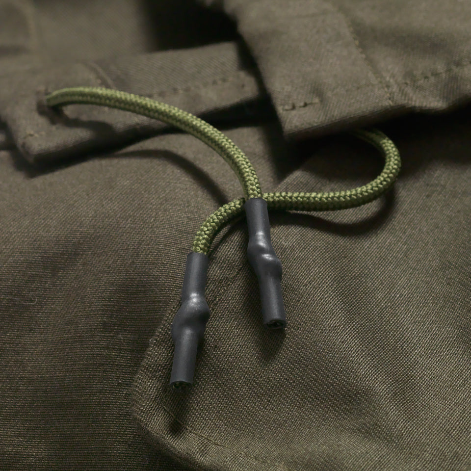 Rubber cord on green military coat. 