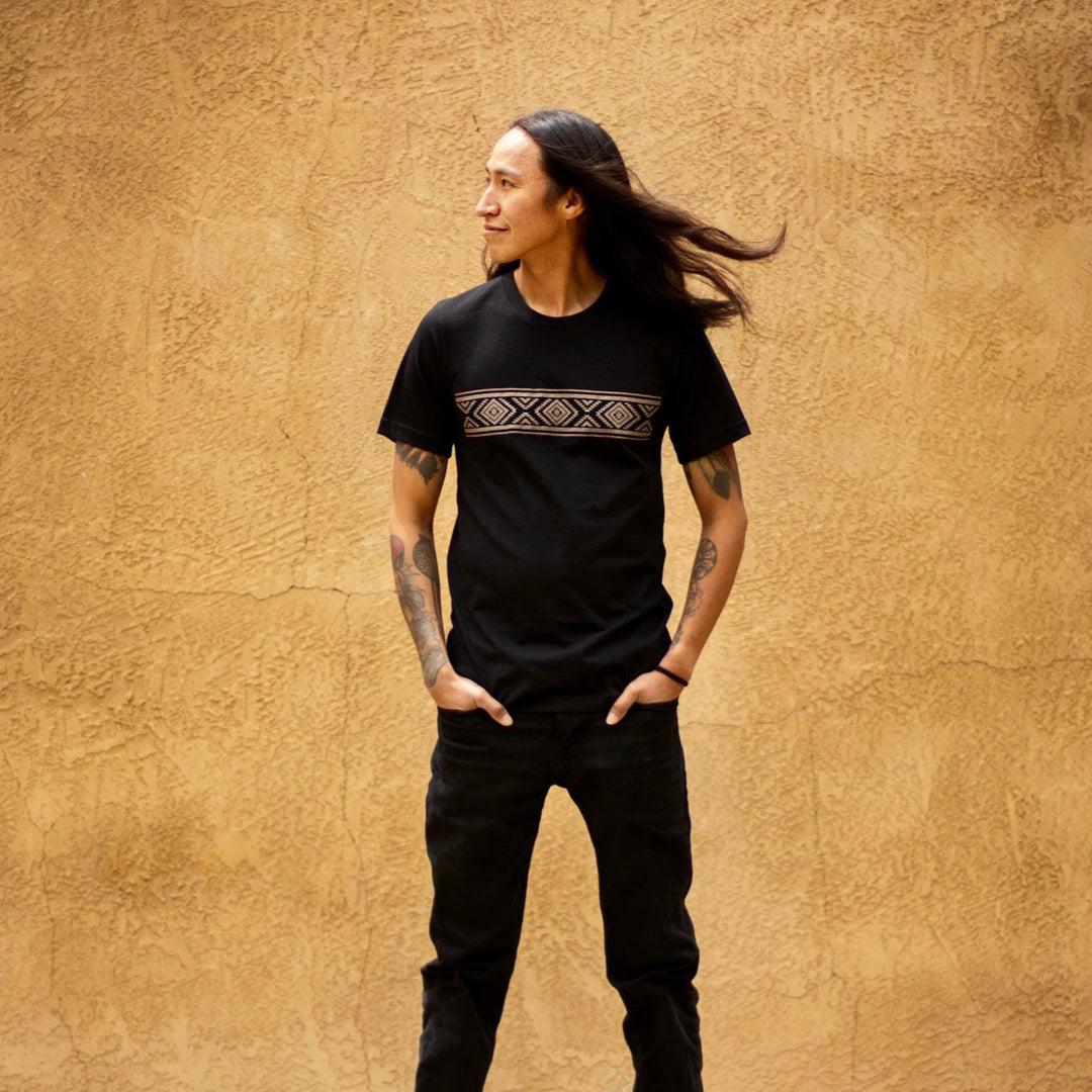 Native American model wearing black cotton graphic t-shirt with diamond design in tan