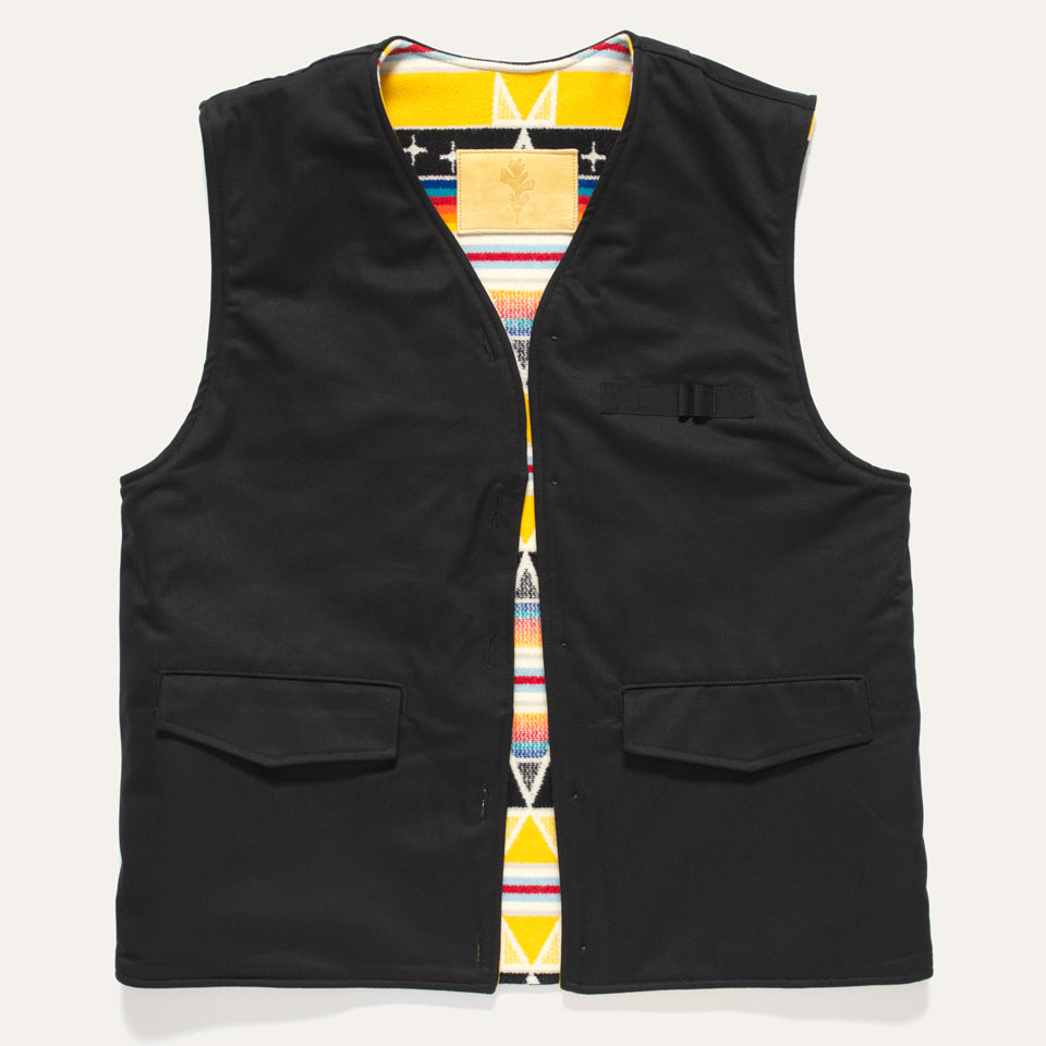 Black side of Reversible vest in black and yellow pattern show inside. Vest is part of a 4-1 coat. 