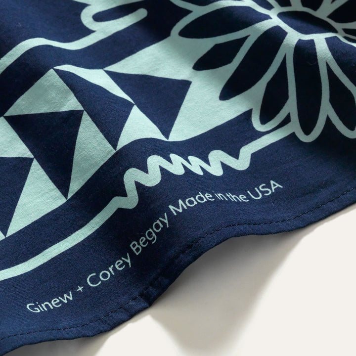 Close up of the printed tag which reads "Ginew + Corey Begoy / Made in the USA"