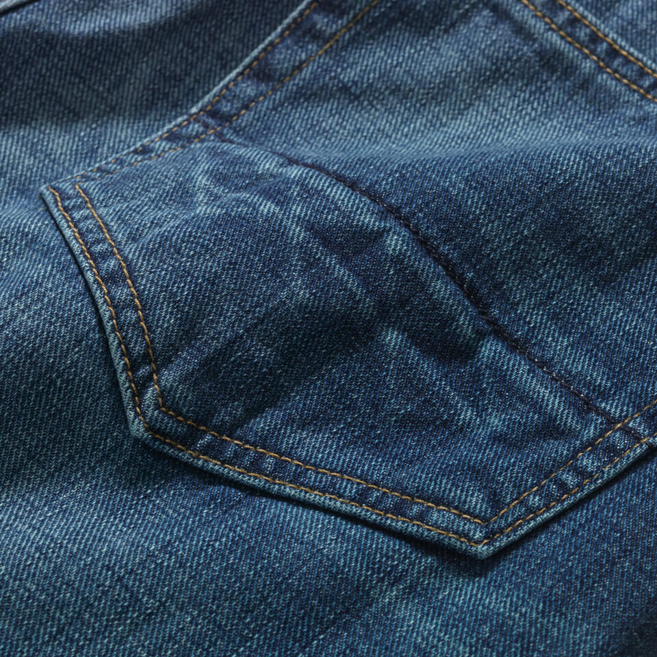 Close up of back pocket of Raven Jean that has a chevron wash faded into it.
