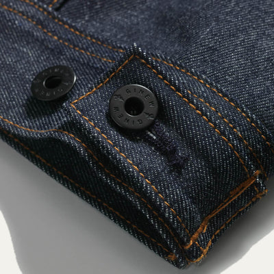 Close up of the bottom of the back of Thunderbird Jacket which features black Ginew buttons.
