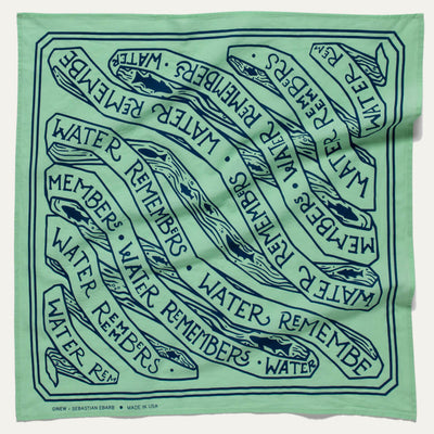 Mint green bandana with navy screen printing design with the words "water remembers" and fish