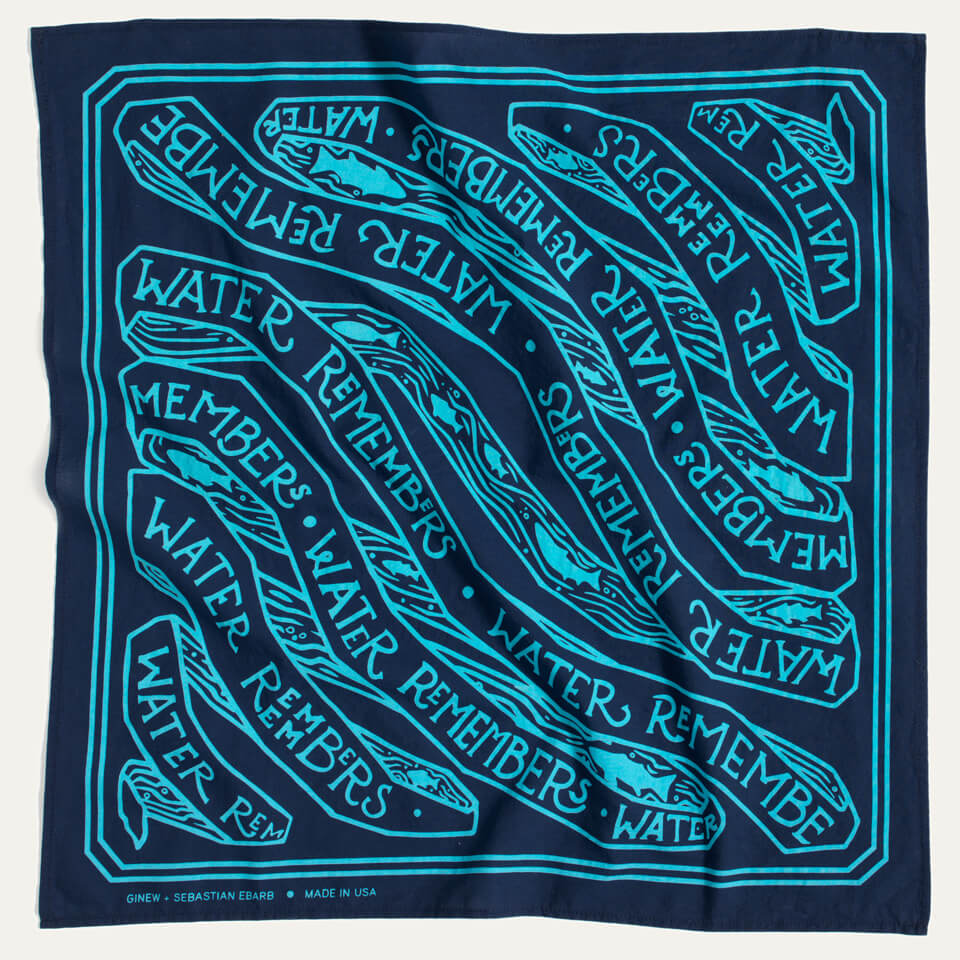 Navy bandana with aqua blue screen printing design with the words "water remembers" and fish the words Ginew and MADE in USA are in the botton right corner. 