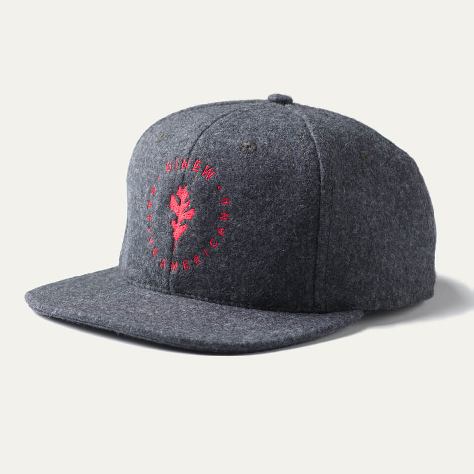A grey wool ball cap featuring a red Ginew leaf embroidered on front. White background. 