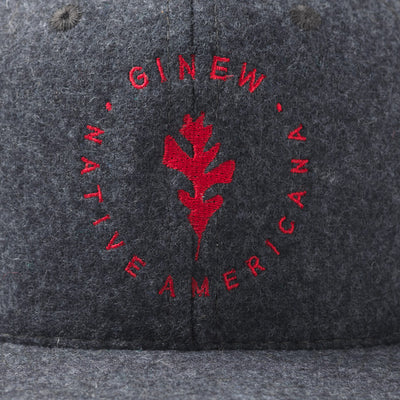 Close up of Ginew Leaf logo embroidered in red on front of the grey wool cap.