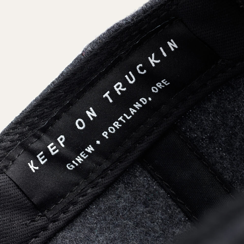 Detail image of the brand tag in the hat band. Tag text says "Keep on truckin' Ginew / Portland, ORE"