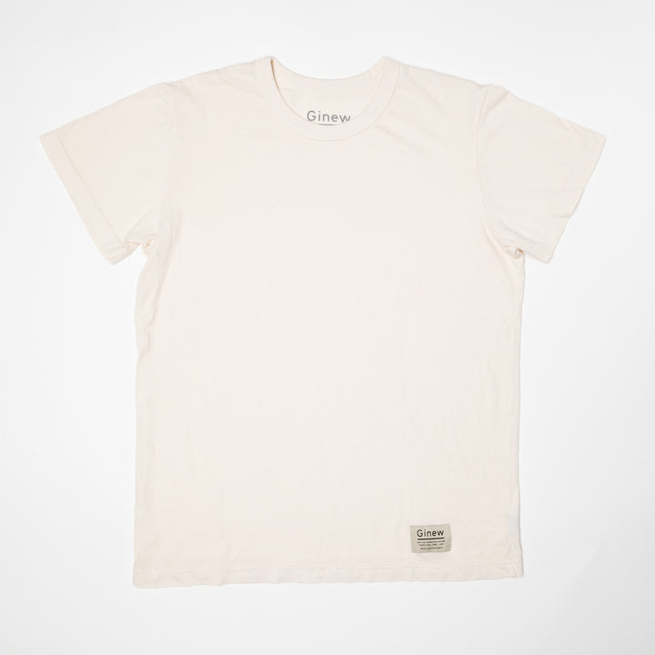 A crew t-shirt in an Arctic Wolf white is laid flat on a white background. The shirt has a white tag at the bottom left hem with the word Ginew on it.