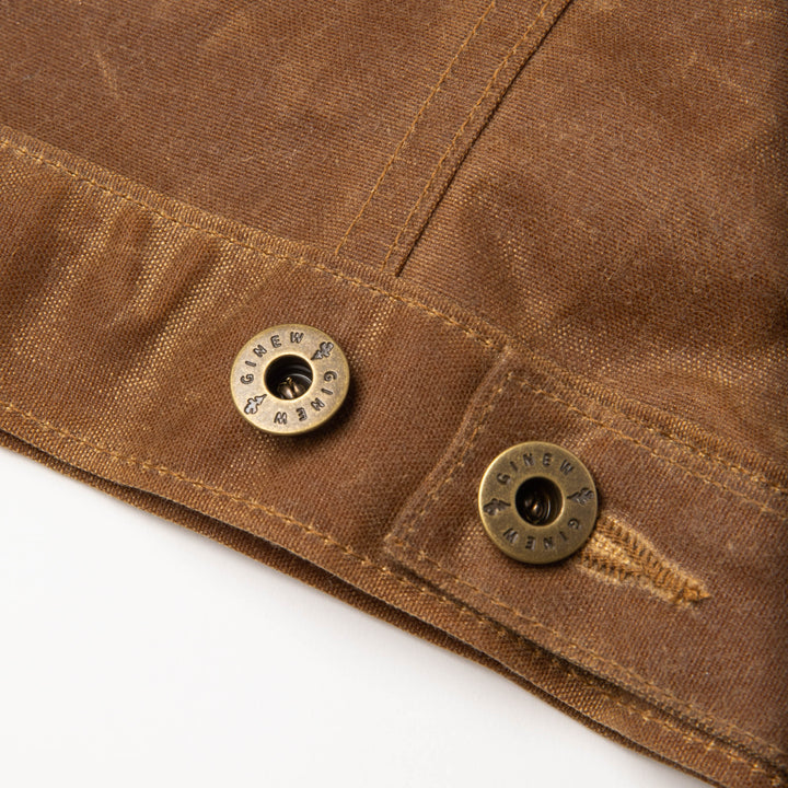 Detail view of custom hardware and adjustable button on back hem.