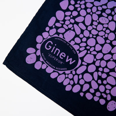 Close-up of bandana with purple and black Superior print.