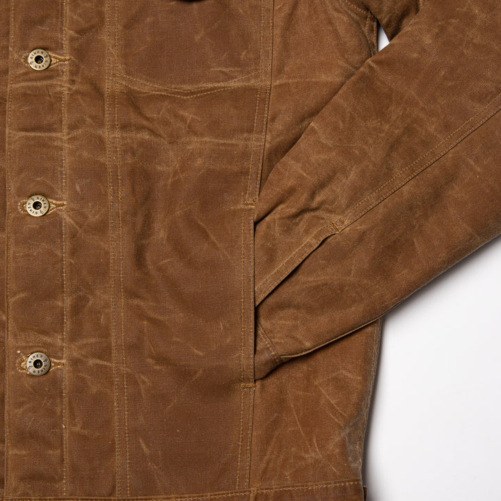 Details of front side pocket, sleeve shown tucked into pocket.